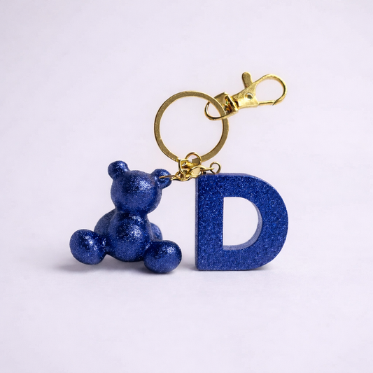 Blue handmade resin bear keychain with the letter D