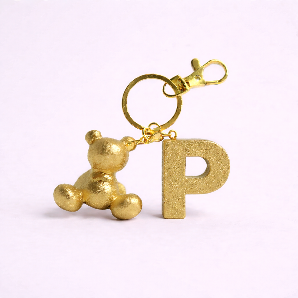 Gold handmade resin bear keychain with the letter P