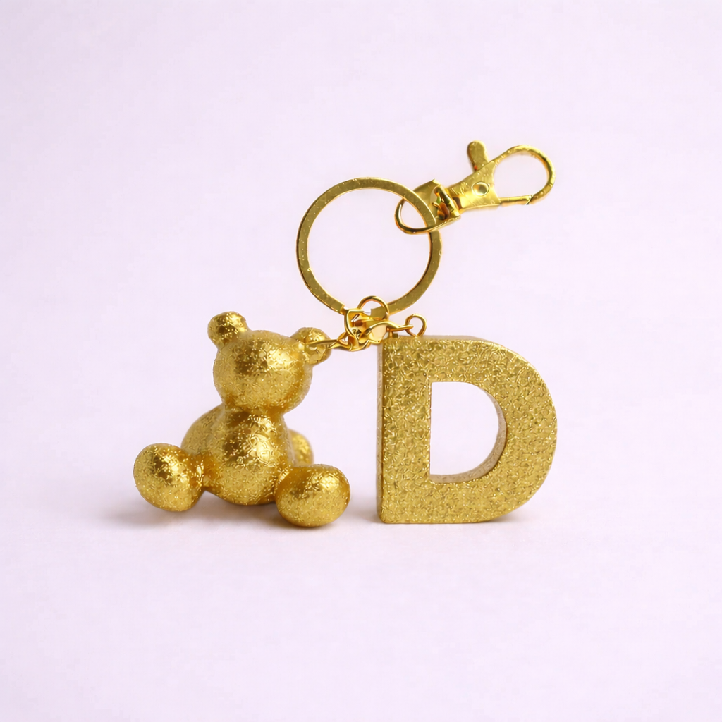 Gold handmade resin bear keychain with the letter D