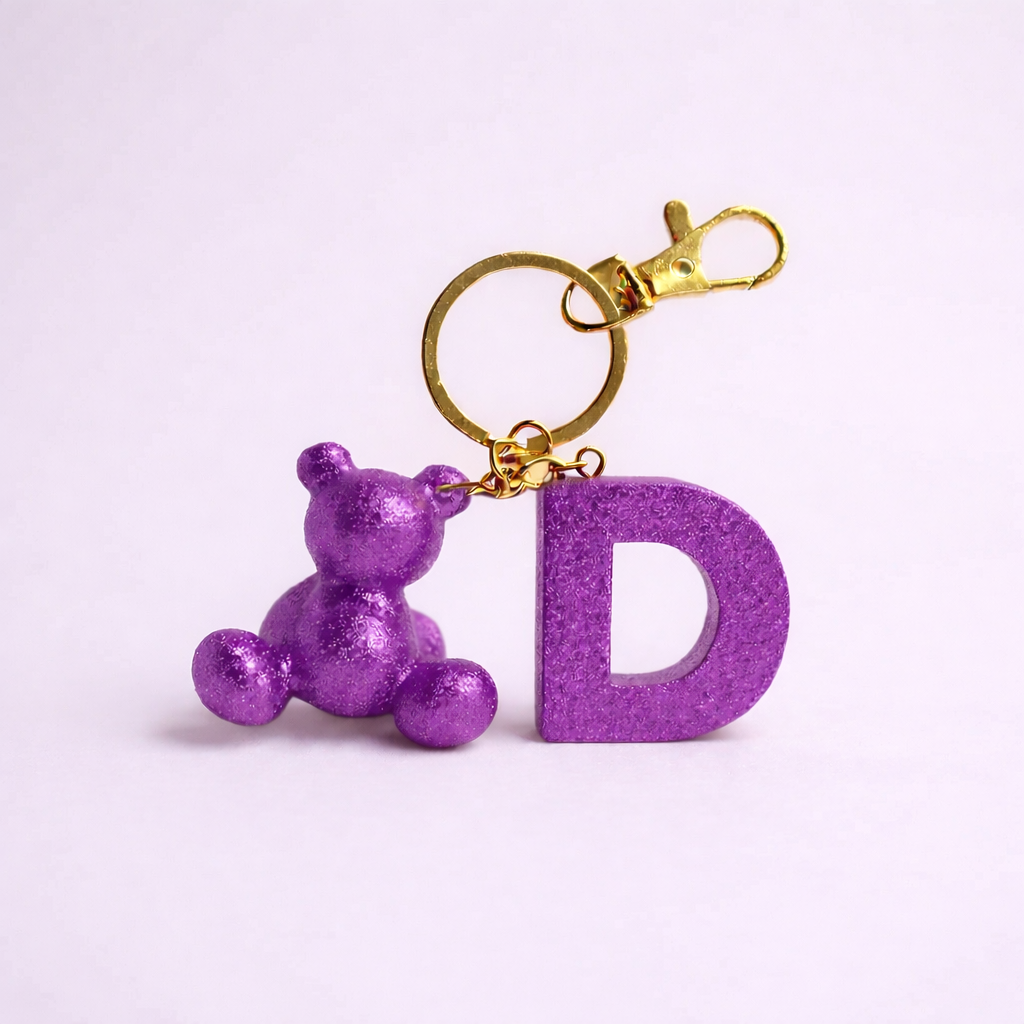 Purple handmade resin bear keychain with the letter D