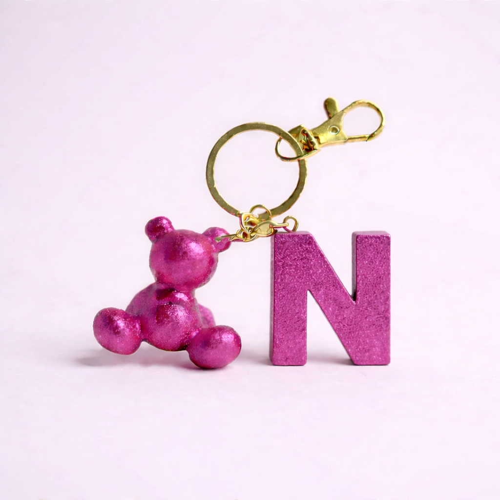 Pink handmade resin bear keychain with the letter N