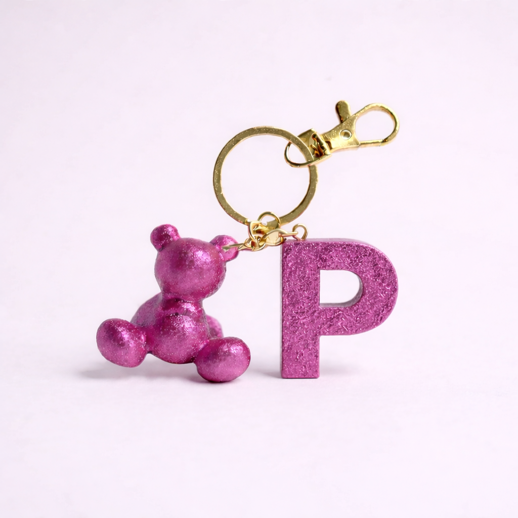 Pink handmade resin bear keychain with the letter P