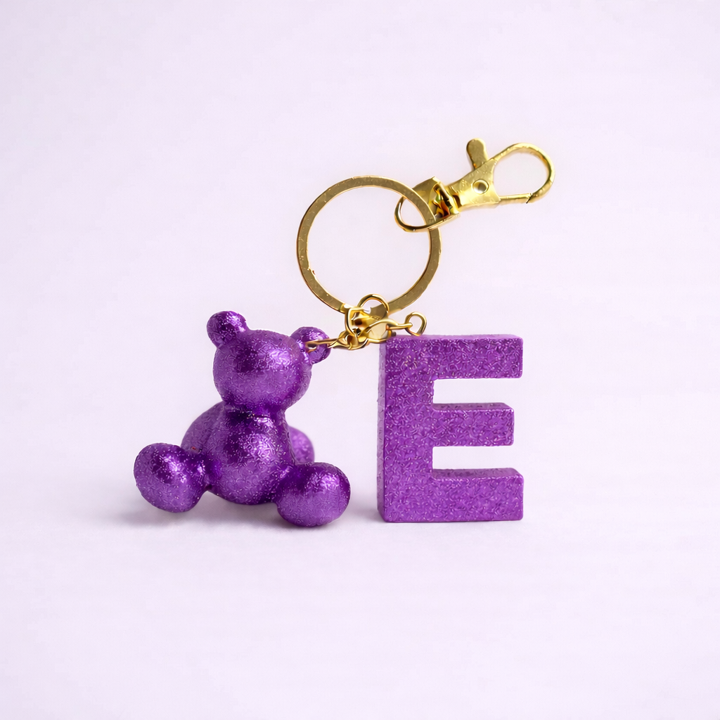 Purple handmade resin bear keychain with the letter E