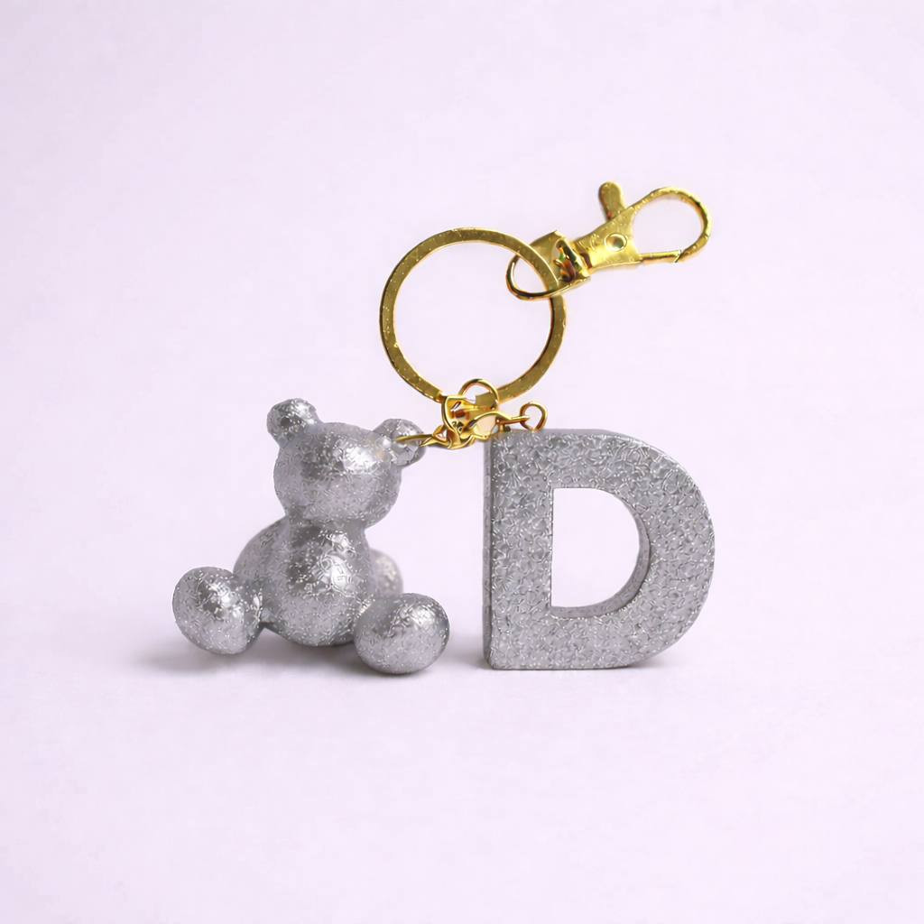 Silver handmade resin bear keychain with the letter D